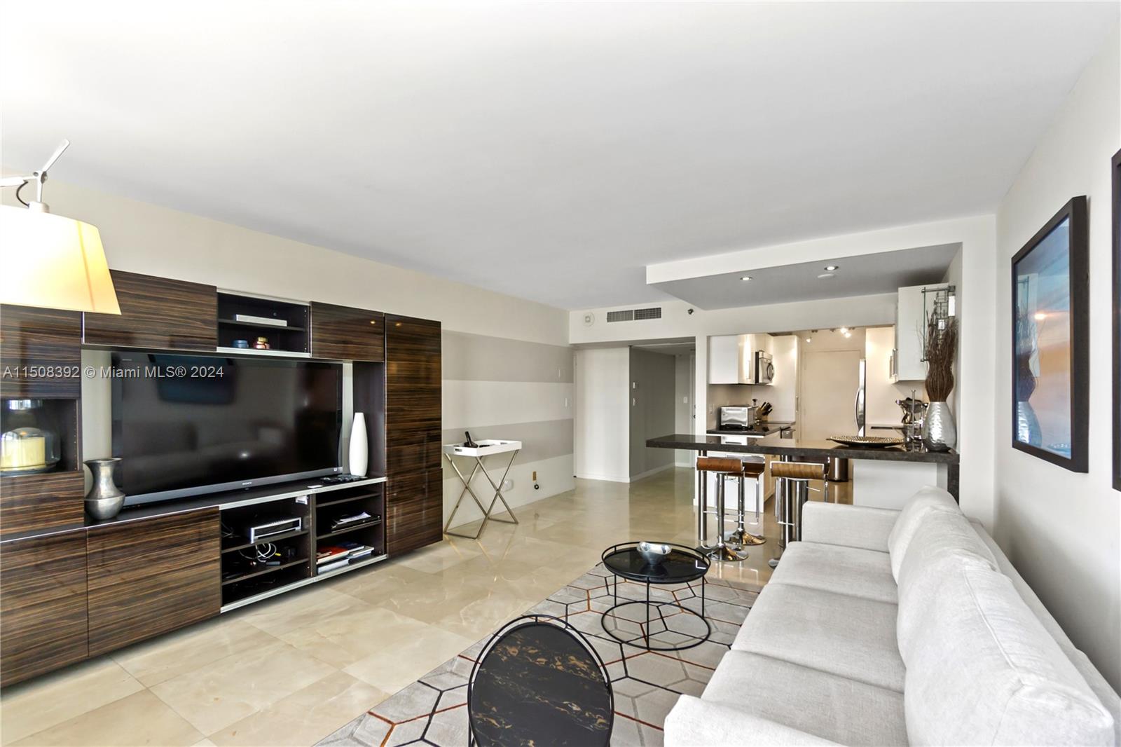 100 Lincoln Road, Unit 1202 Miami Beach, FL 33139 - Photo 2 of 23 a living room with furniture and a flat screen tv
