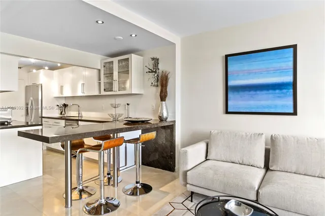 a kitchen with stainless steel appliances granite countertop a stove and a refrigerator