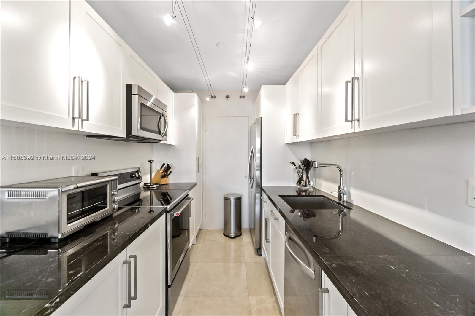 100 Lincoln Road, Unit 1202 Miami Beach, FL 33139 - Photo 6 of 23 a kitchen with stainless steel appliances granite countertop a sink stove and refrigerator