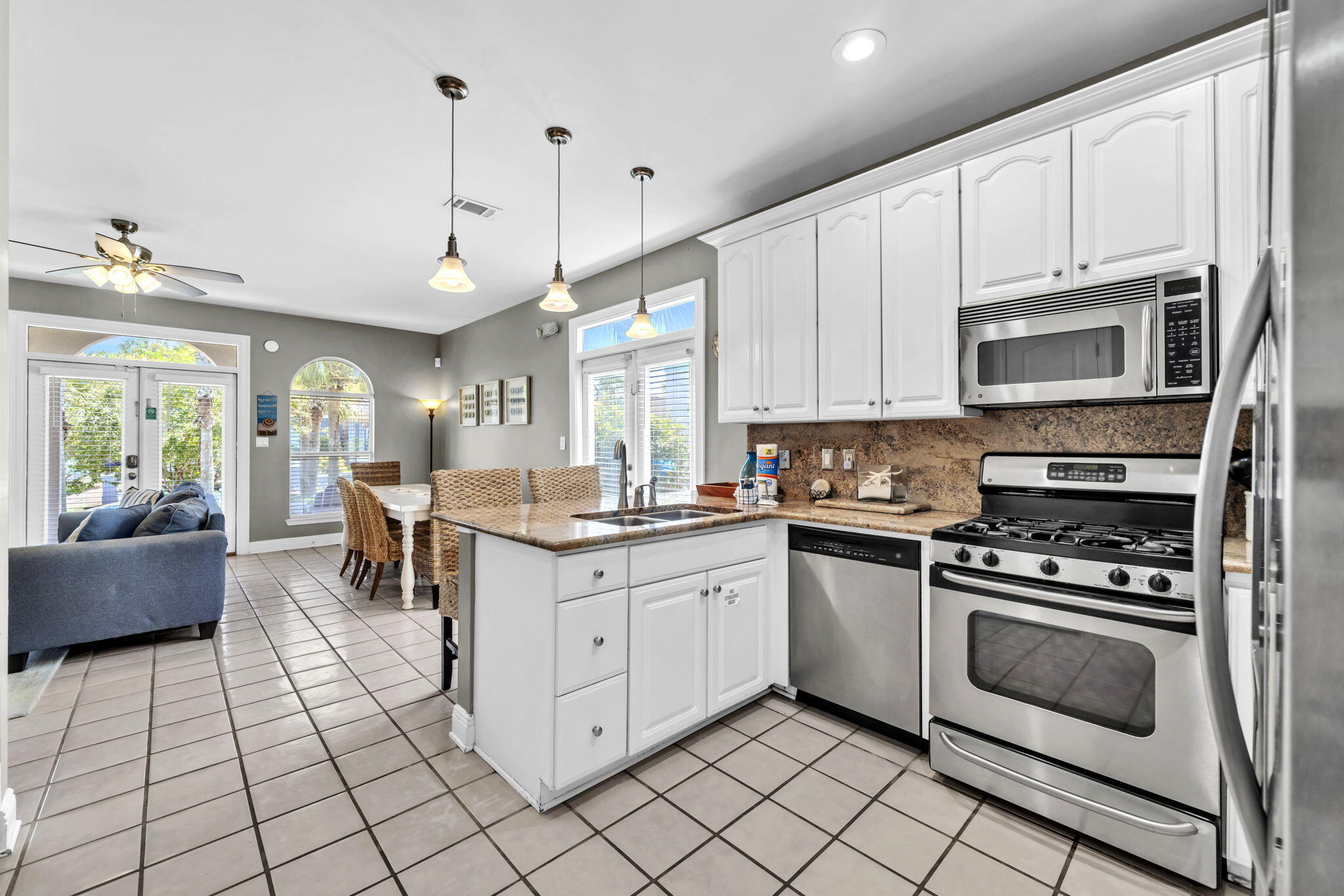 80 Terra Cotta Way Destin, FL 32541 - Photo 16 of 84 a kitchen with stainless steel appliances a stove a sink cabinets and a window
