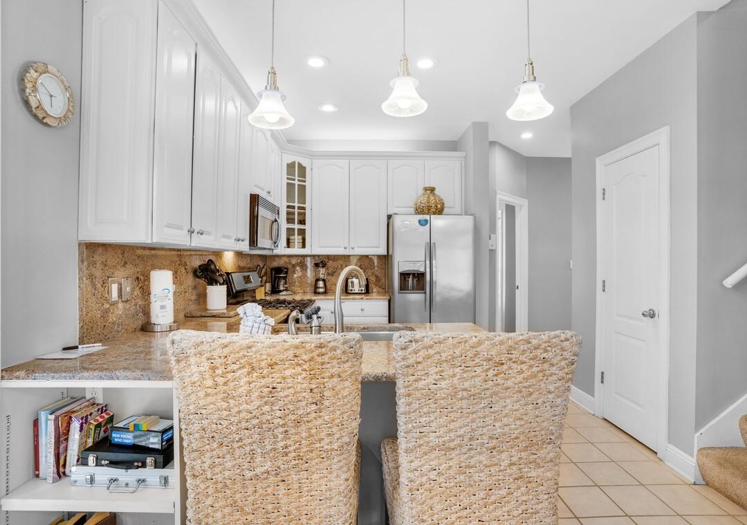 80 Terra Cotta Way Destin, FL 32541 - Photo 17 of 84 a kitchen with stainless steel appliances kitchen island granite countertop a refrigerator and a stove