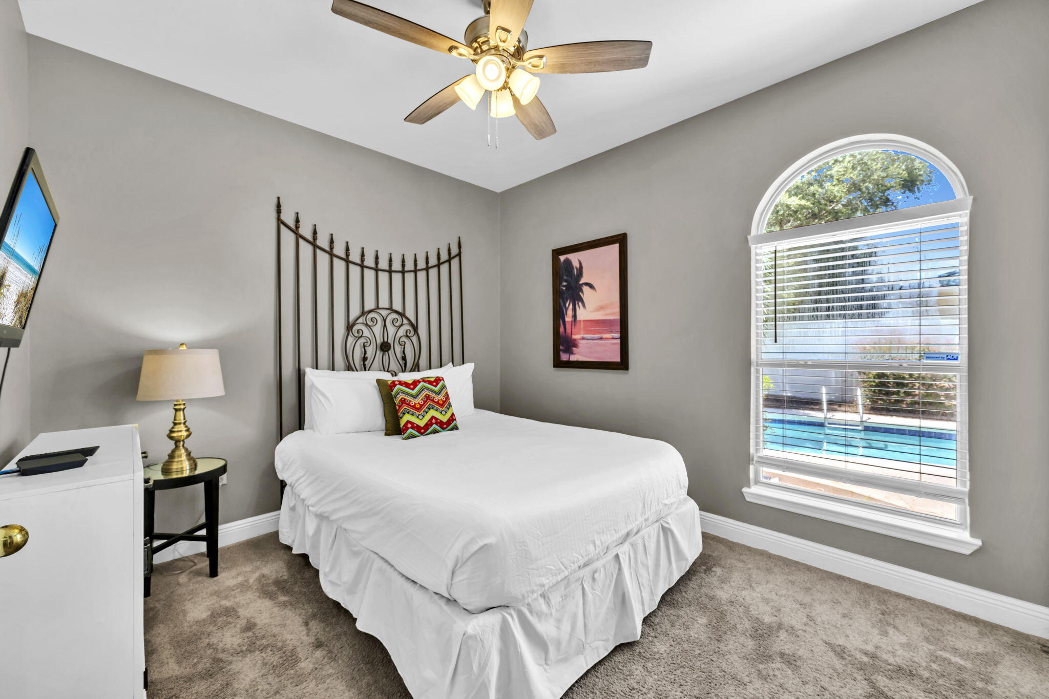 80 Terra Cotta Way Destin, FL 32541 - Photo 33 of 84 a bedroom with a bed a chandelier and a window