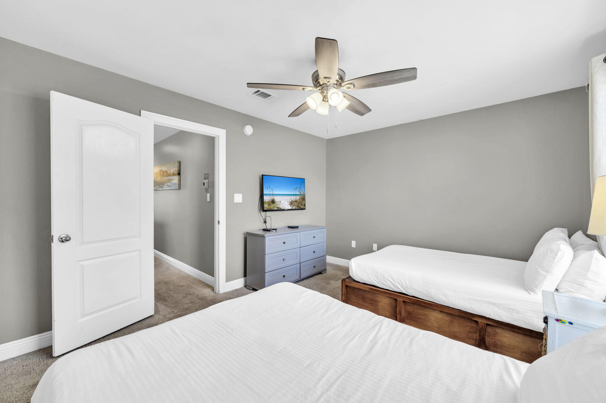 80 Terra Cotta Way Destin, FL 32541 - Photo 38 of 84 a bedroom with a bed and a chandelier