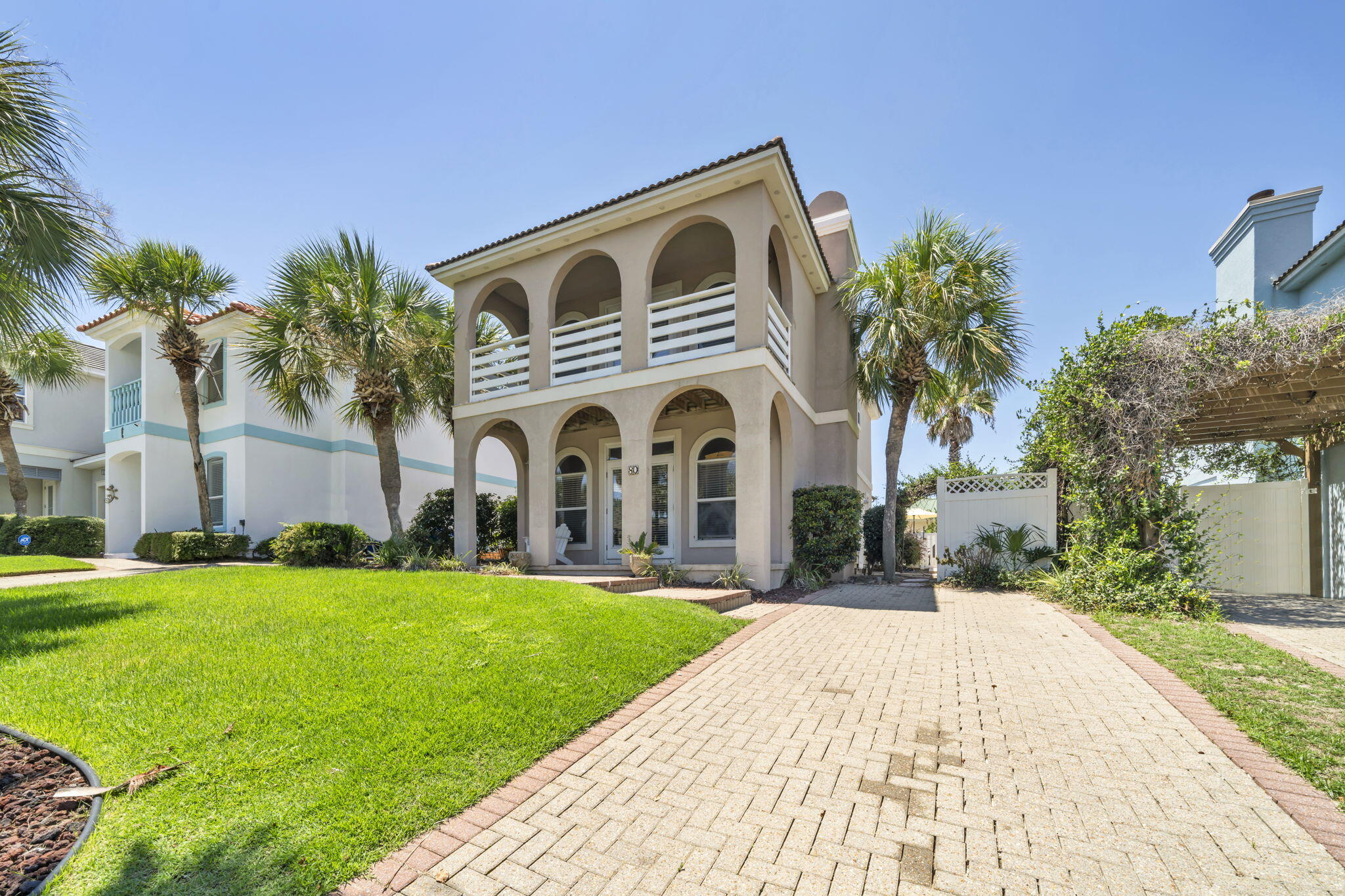80 Terra Cotta Way Destin, FL 32541 - Photo 4 of 84 a front view of a house with a garden