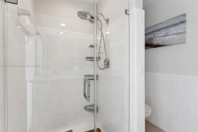 a bedroom with two beds and a ceiling fan