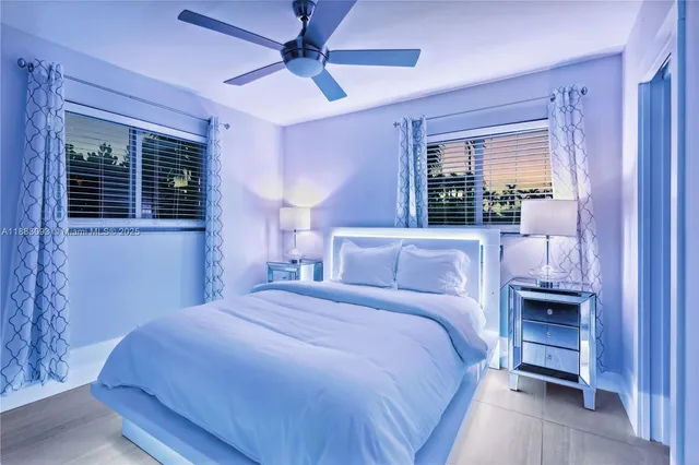 a view of a livingroom with a window and kitchen view