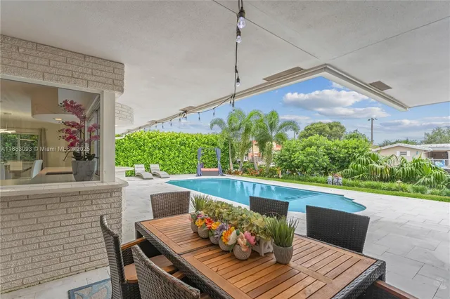 a view of a house with swimming pool and sitting area