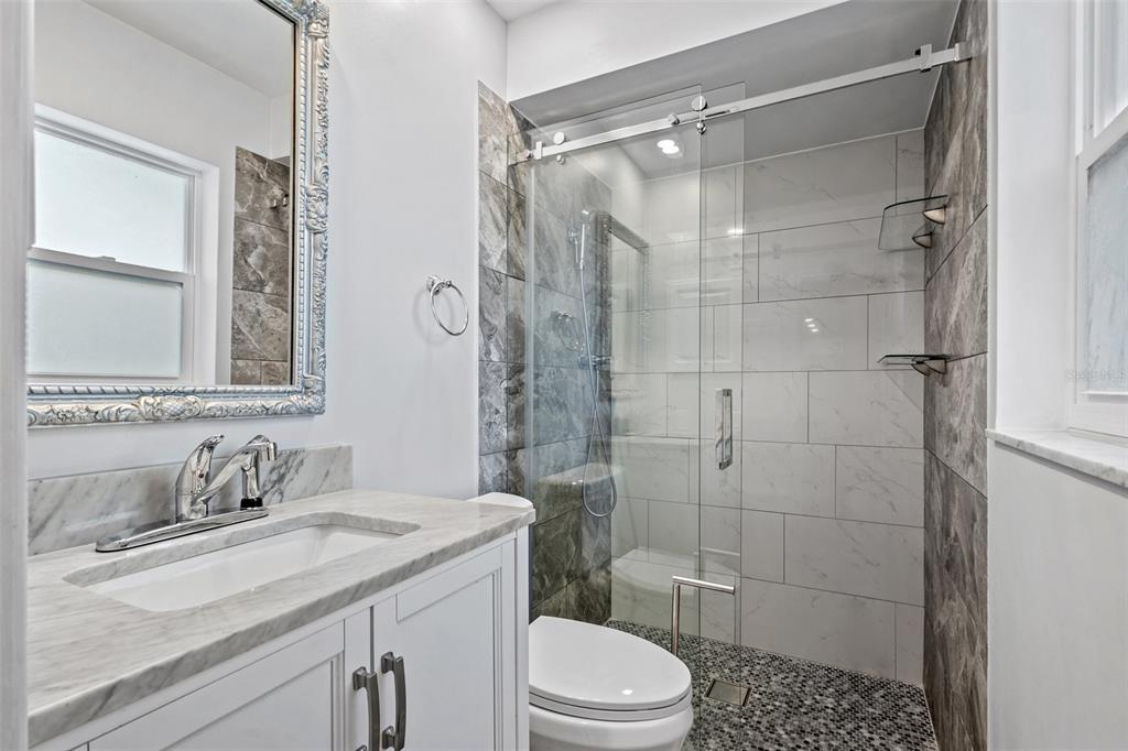 2033 Little Neck Road Clearwater, FL 33755 - Photo 25 of 39 Fully remodeled bathroom 1 with walk-in shower