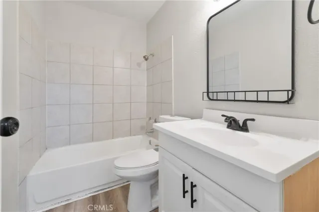 a bathroom with a sink a toilet and bathtub