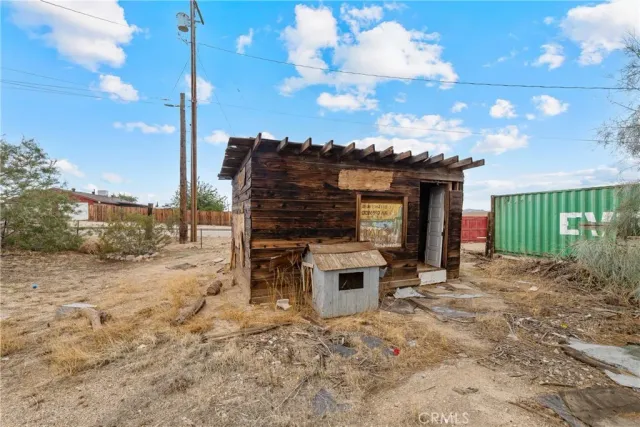 a view of a house with a patio and a yard