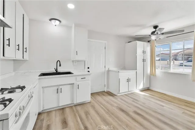a kitchen with a sink stove and cabinets