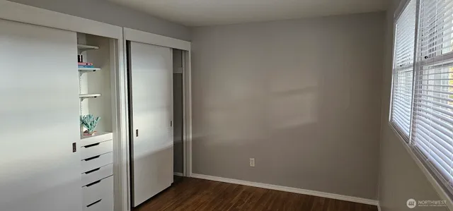 an empty room with wooden floor