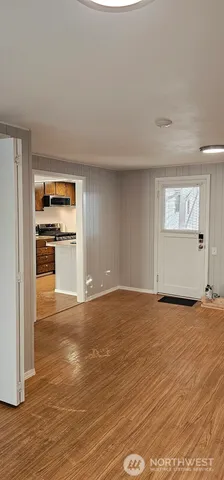a view of a kitchen with a sink and a refrigerator