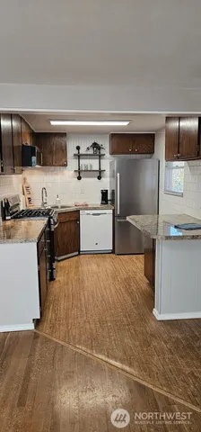 a kitchen with stainless steel appliances a sink and a stove top oven