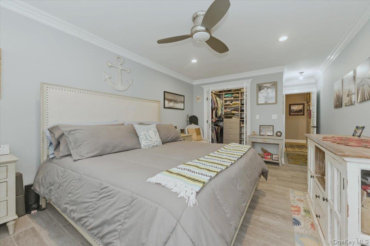 711 Shore Road, Unit 1J Long Beach, NY 11561 - Photo 12 of 22 a spacious bedroom with a bed and ceiling fan