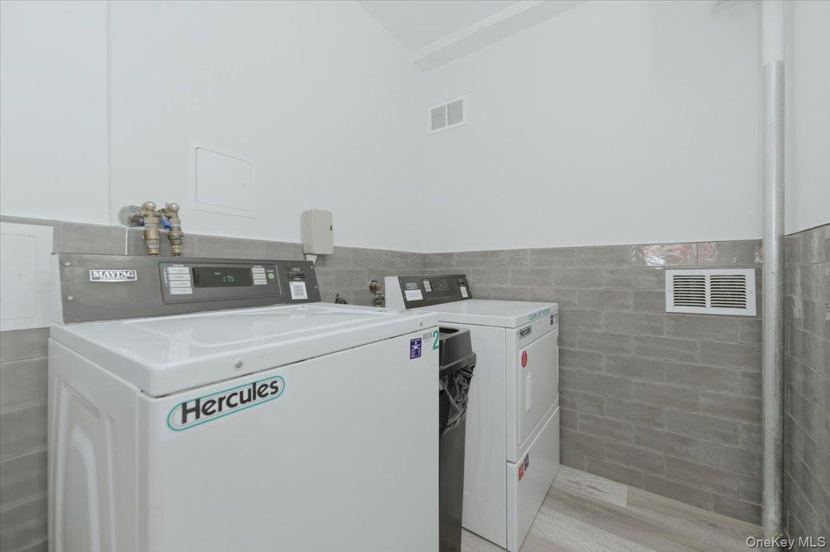 711 Shore Road, Unit 1J Long Beach, NY 11561 - Photo 20 of 22 a utility room with washer and dryer