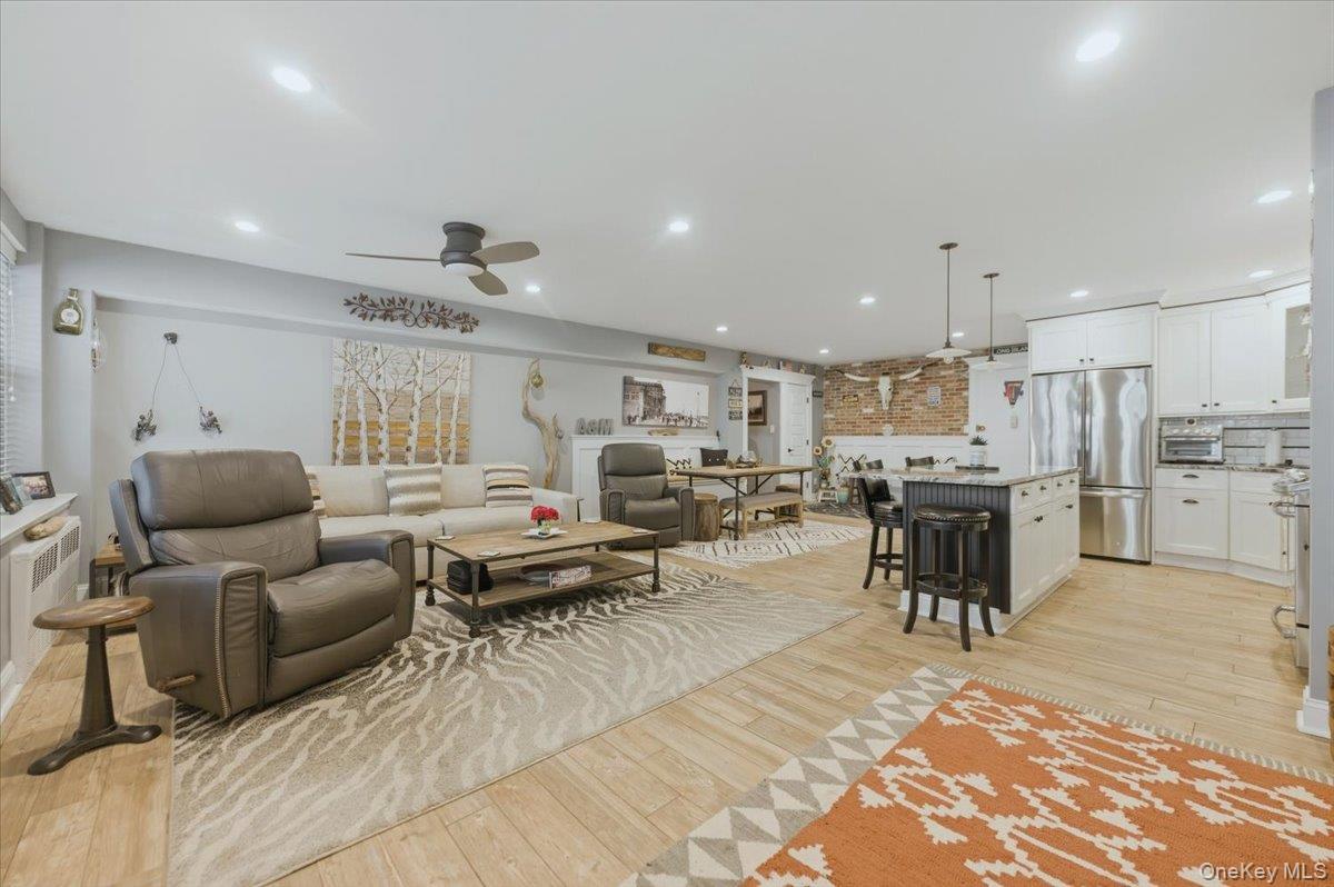 711 Shore Road, Unit 1J Long Beach, NY 11561 - Photo 6 of 22 a living room with lots of furniture and view of kitchen
