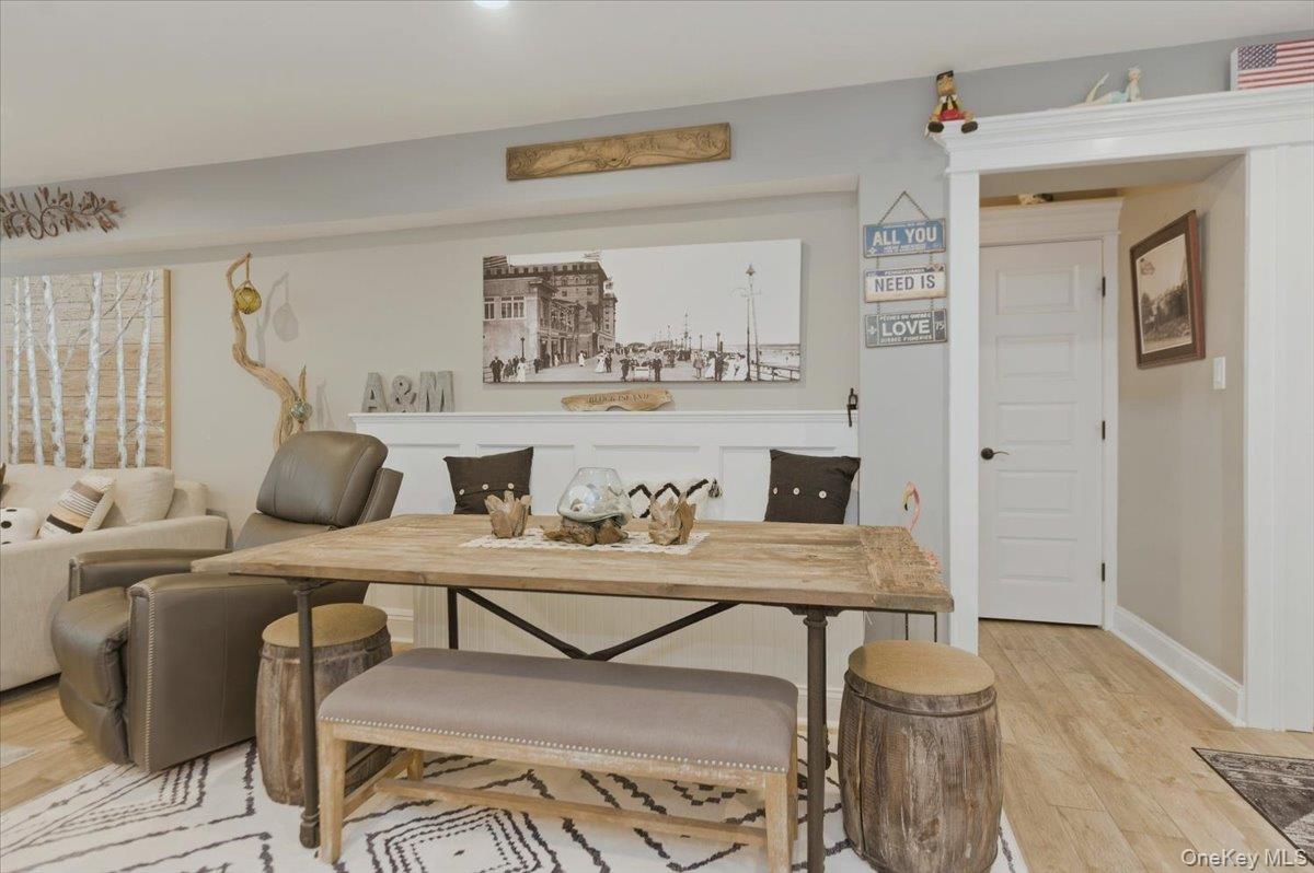 711 Shore Road, Unit 1J Long Beach, NY 11561 - Photo 7 of 22 a living room with furniture and wooden floor