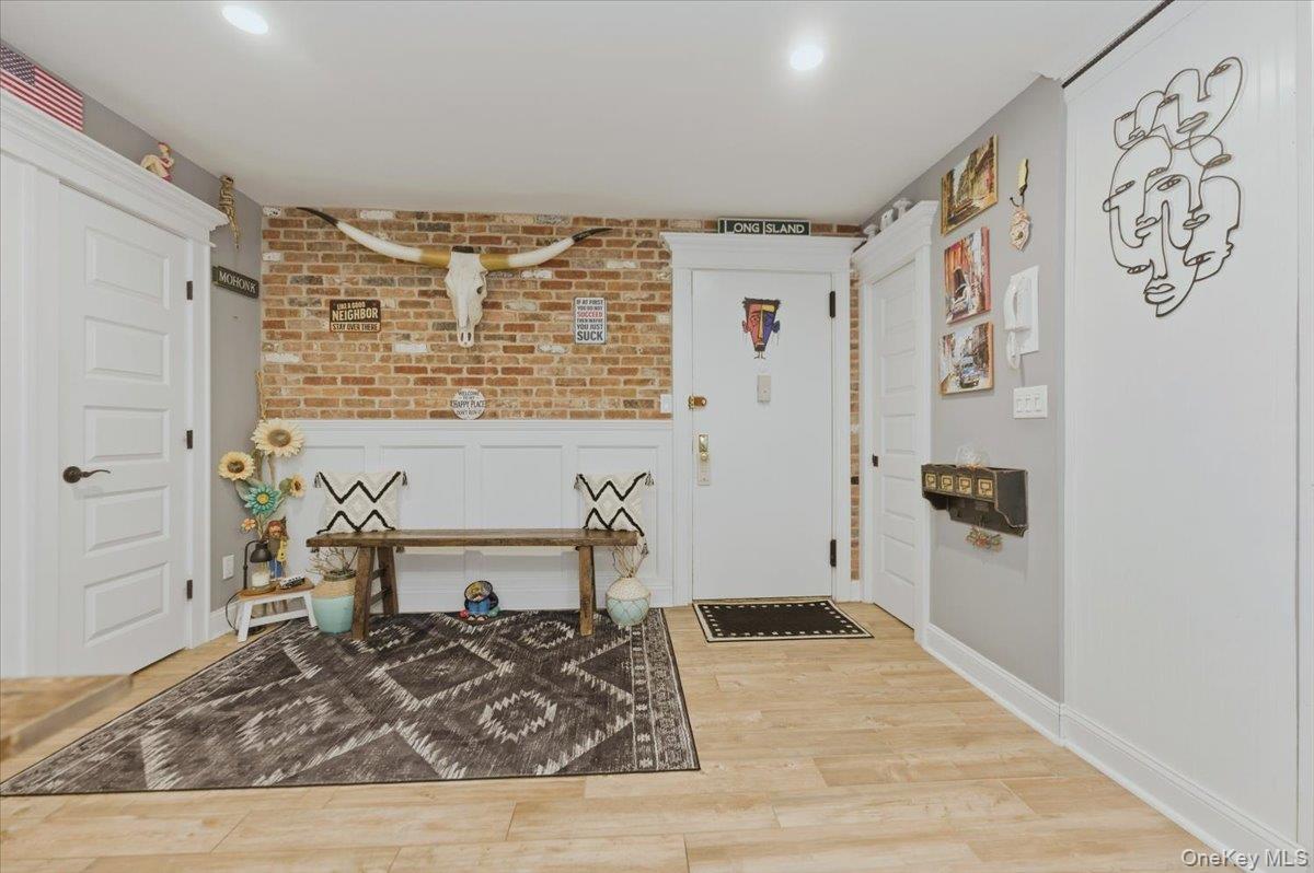 711 Shore Road, Unit 1J Long Beach, NY 11561 - Photo 8 of 22 a living room with a couch and a table with wooden floor