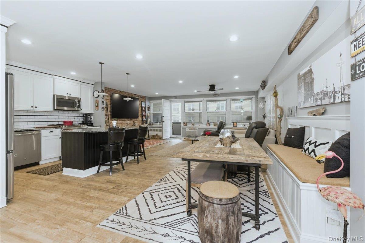 711 Shore Road, Unit 1J Long Beach, NY 11561 - Photo 9 of 22 a living room with stainless steel appliances furniture a rug and a kitchen view