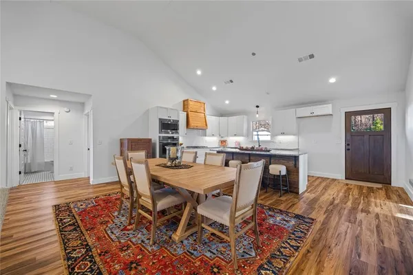a kitchen with granite countertop white cabinets and window