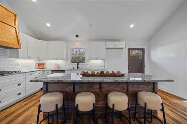 a stove top oven sitting inside of a kitchen