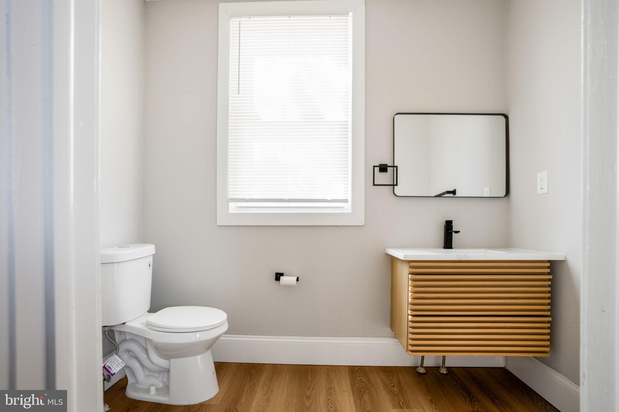 246 Chestnut Street Mount Holly, NJ 08060 - Photo 11 of 25 a bathroom with a sink a toilet and mirror