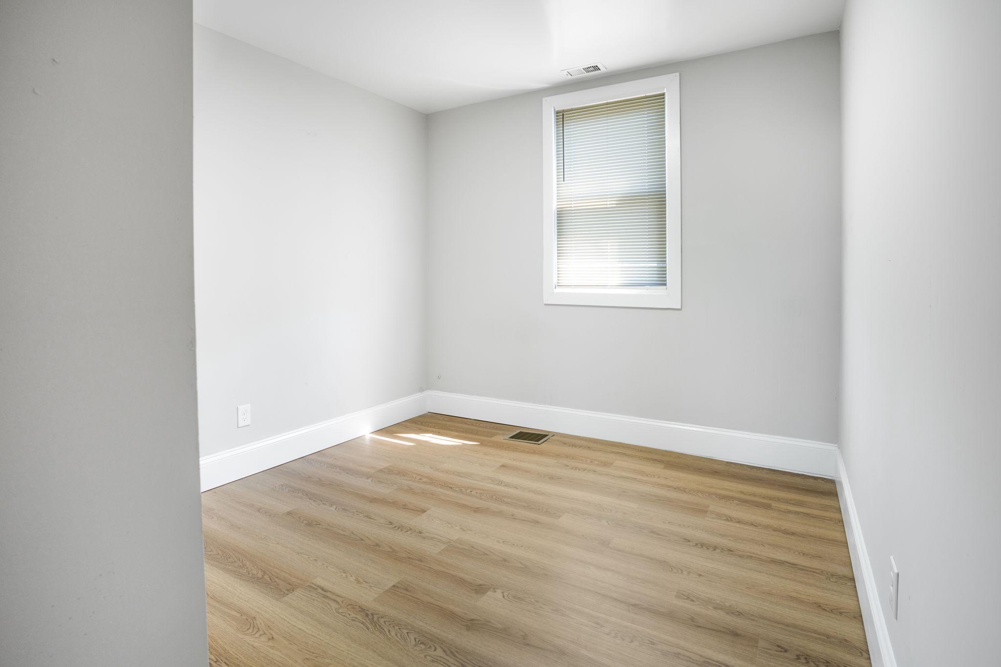 246 Chestnut Street Mount Holly, NJ 08060 - Photo 12 of 25 a view of an empty room with wooden floor and a window