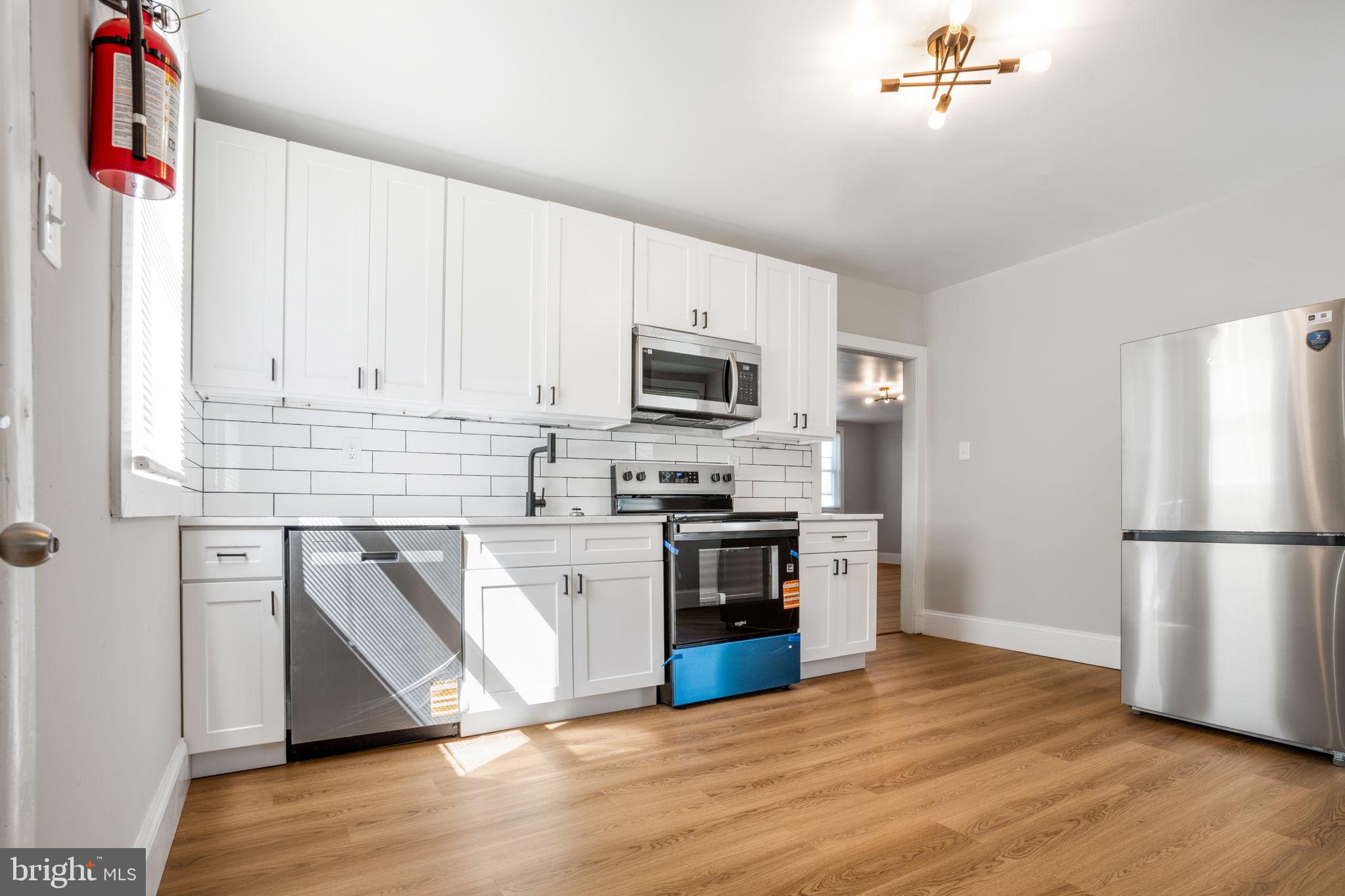 246 Chestnut Street Mount Holly, NJ 08060 - Photo 22 of 25 a kitchen with granite countertop a refrigerator stove top oven and sink