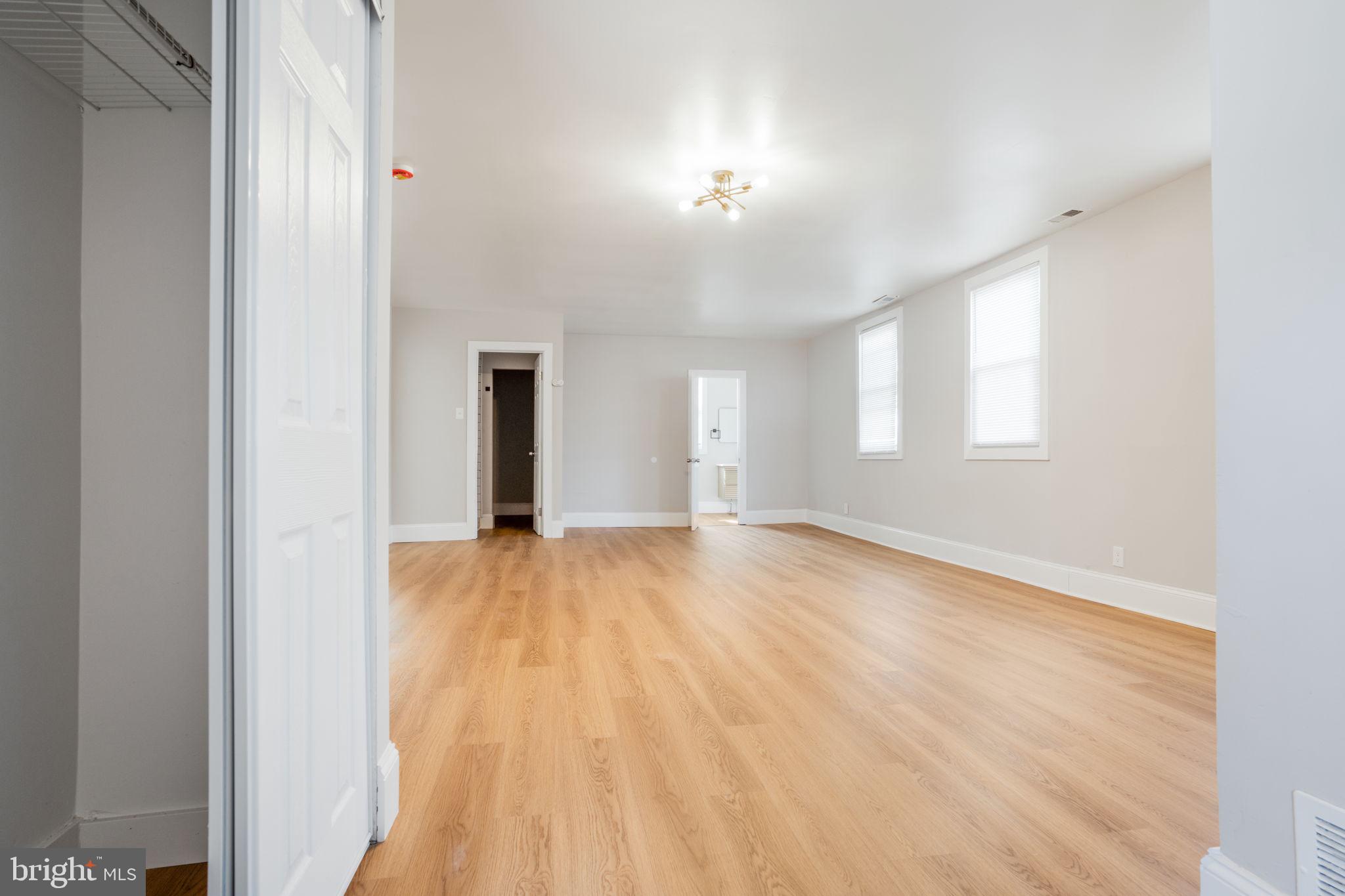 246 Chestnut Street Mount Holly, NJ 08060 - Photo 9 of 25 a view of an empty room with window and wooden floor
