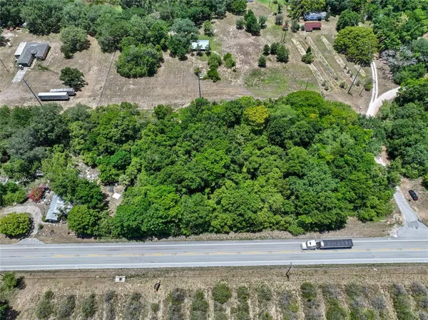 an aerial view of a house with a yard and lake view