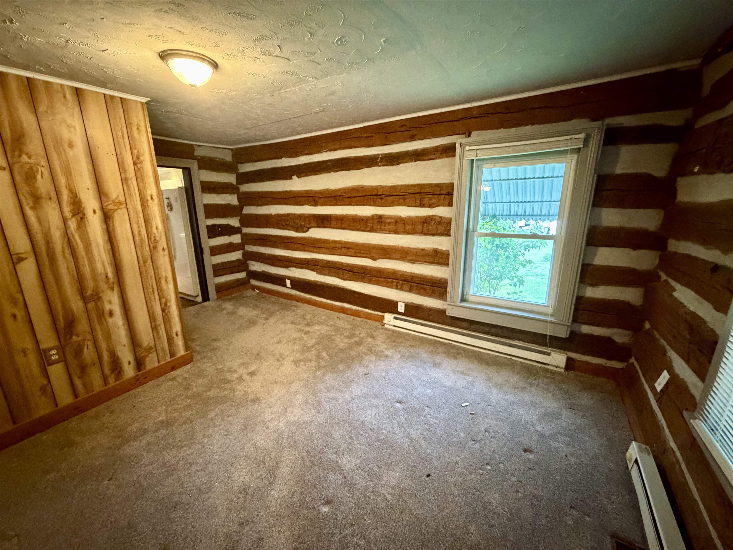 3648 Middlebrook Village Road Middlebrook, VA 24459 - Photo 5 of 48 a view of an empty room with a fireplace and a window