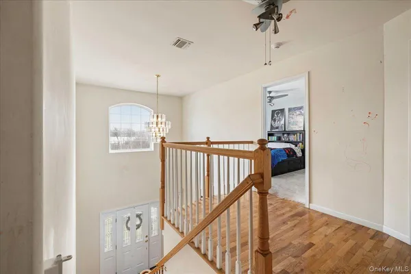 a view of a hallway with a livingroom and stairs