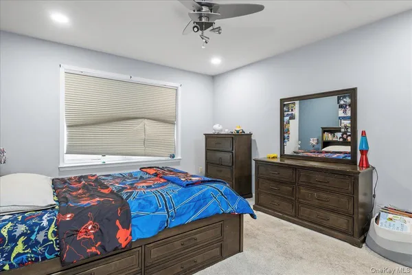 a bedroom with a bed and a dresser in it