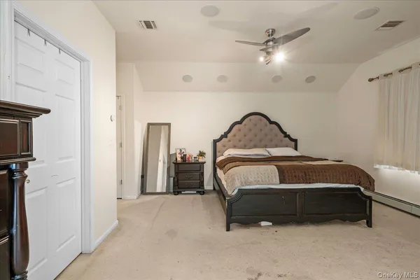 a bedroom with a bed and a ceiling fan