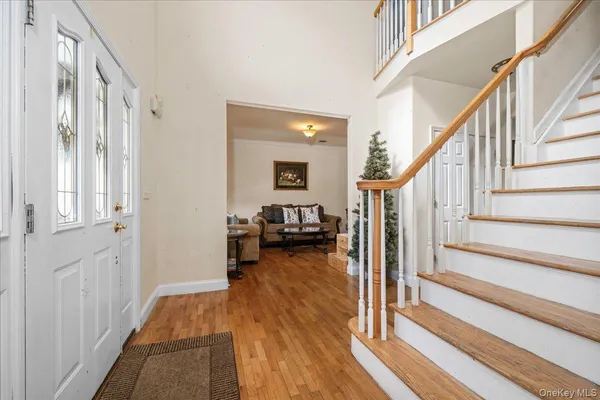 a view of a hallway view with wooden floor and staircase