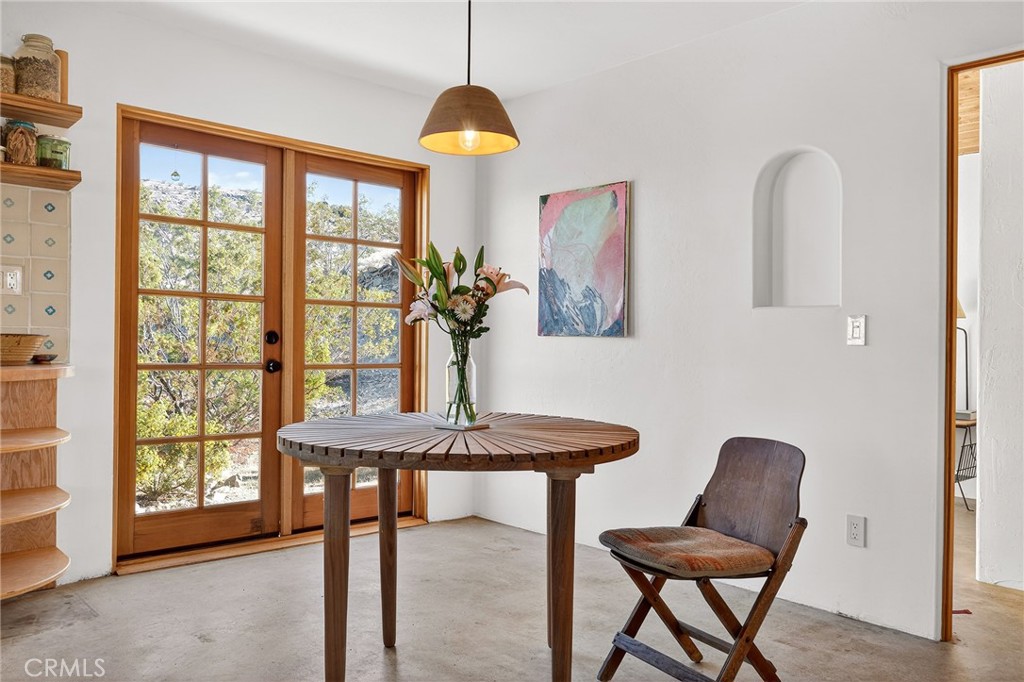 60473 Starlight Road Joshua Tree, CA 92252 - Photo 12 of 39 a view of a dining room with furniture and a window