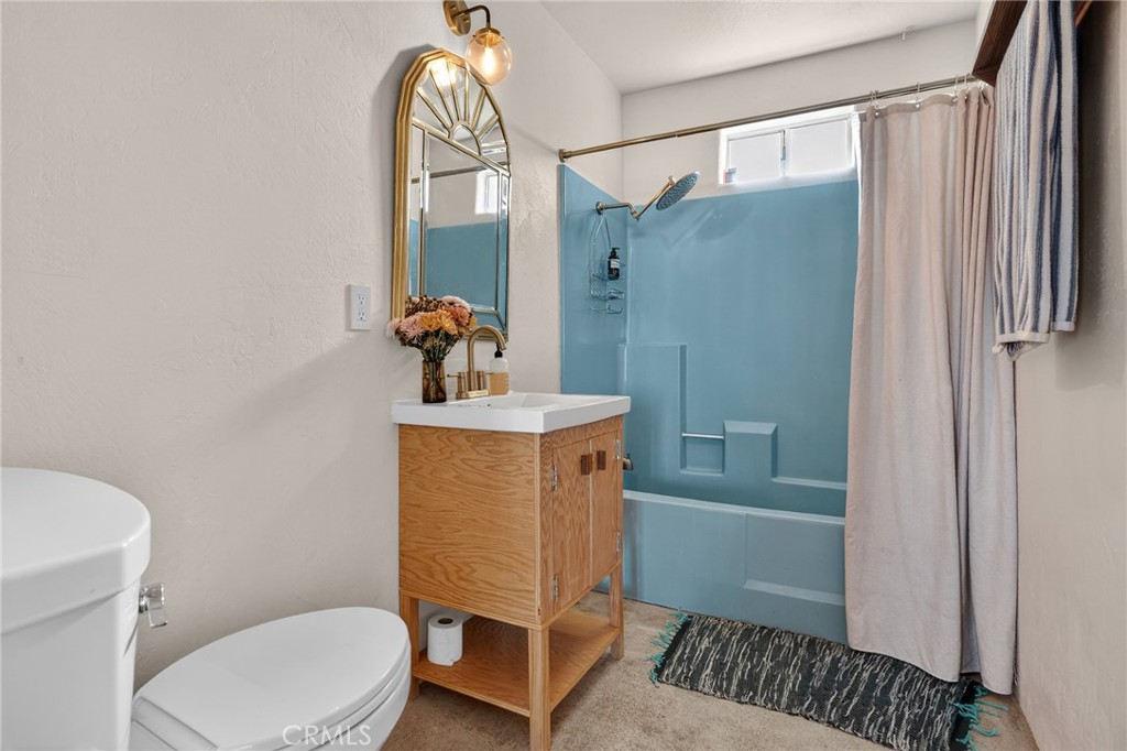 60473 Starlight Road Joshua Tree, CA 92252 - Photo 19 of 39 a bathroom with a toilet a sink and mirror