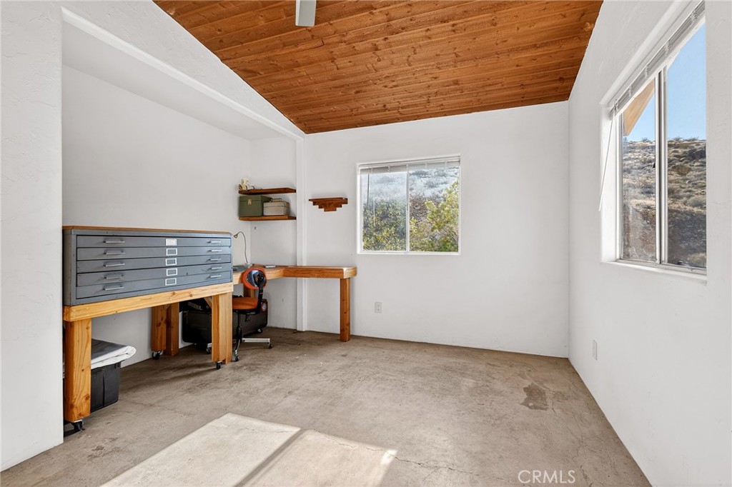 60473 Starlight Road Joshua Tree, CA 92252 - Photo 21 of 39 a view of an empty room with a fireplace