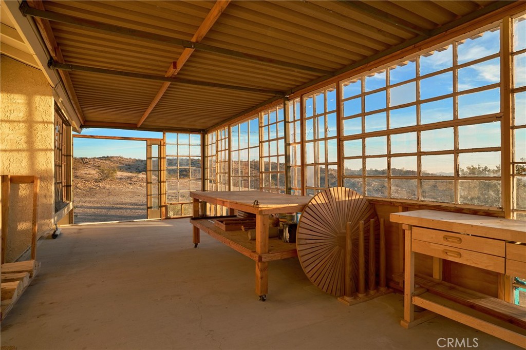 60473 Starlight Road Joshua Tree, CA 92252 - Photo 29 of 39 a bedroom with furniture and large windows