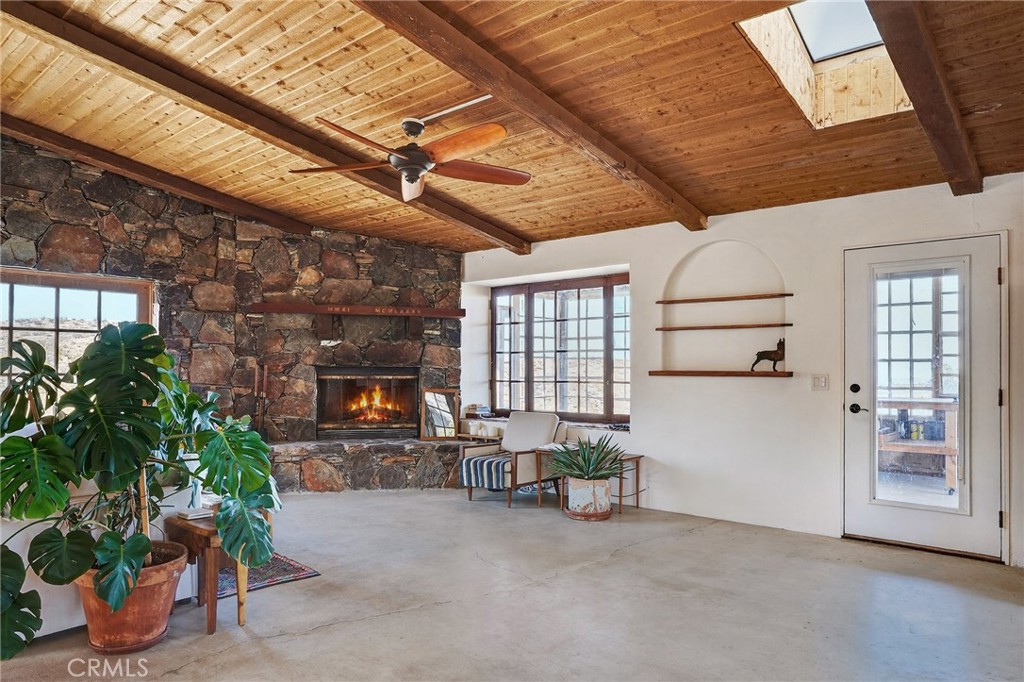 60473 Starlight Road Joshua Tree, CA 92252 - Photo 3 of 39 a living room with furniture and a potted plant