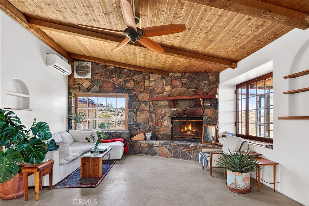 60473 Starlight Road Joshua Tree, CA 92252 - Photo 4 of 39 a living room with furniture a window and potted plants