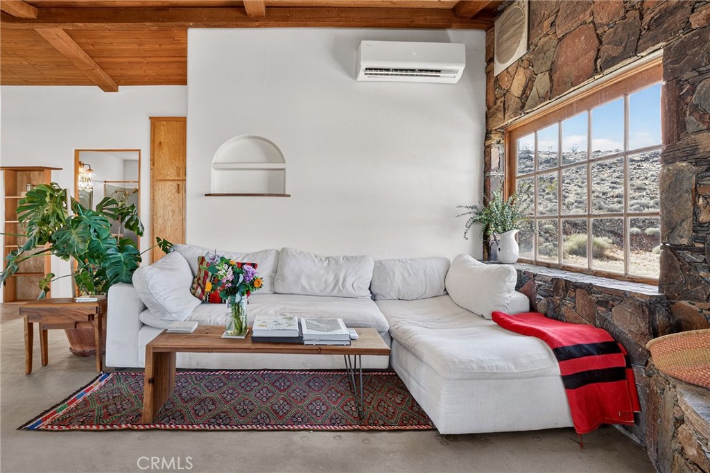 60473 Starlight Road Joshua Tree, CA 92252 - Photo 6 of 39 a living room with furniture and a potted plant