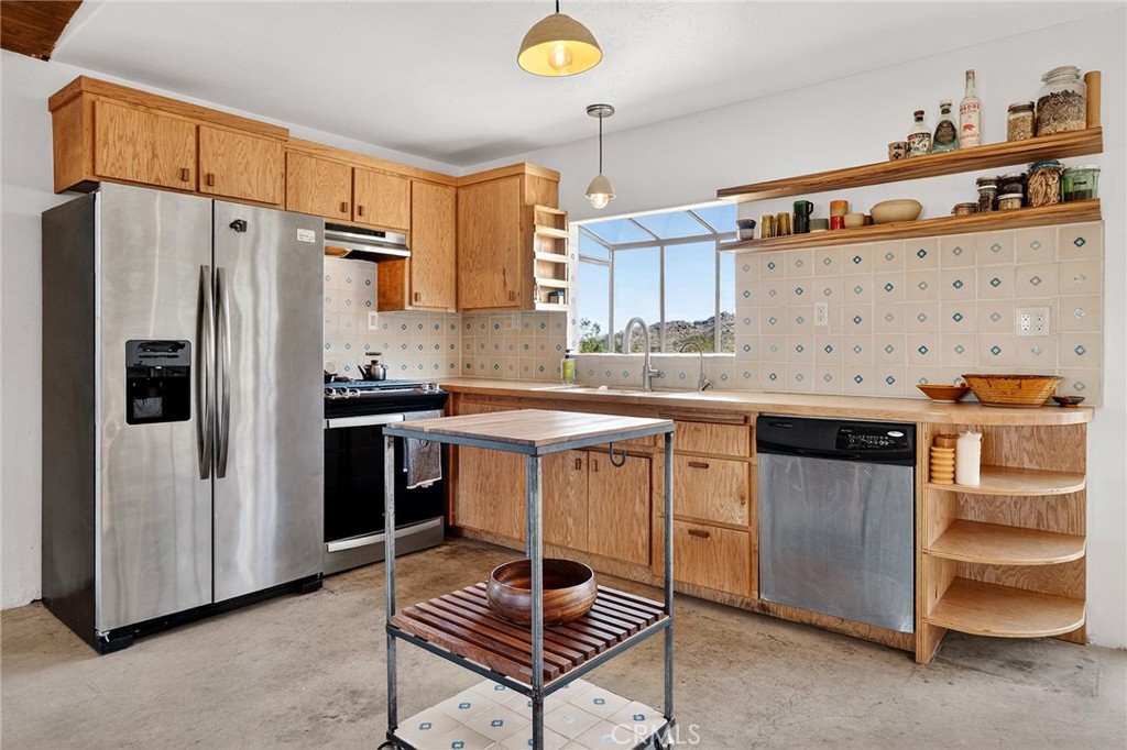 60473 Starlight Road Joshua Tree, CA 92252 - Photo 9 of 39 a kitchen with stainless steel appliances a stove a sink and a refrigerator