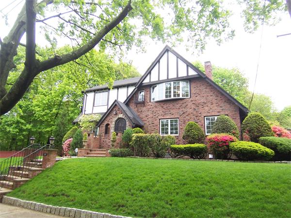 a front view of house with yard and green space