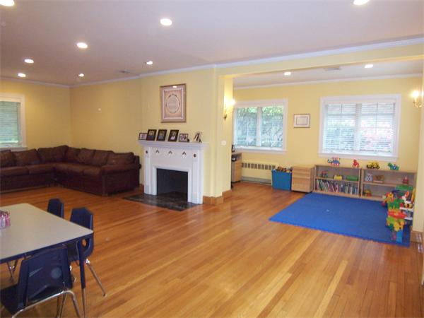 36 Dolphin Road Newton, MA 02459 - Photo 3 of 17 a living room with furniture and a fireplace with wooden floor