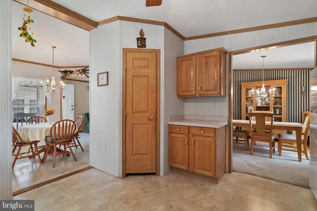 a kitchen with lots of clutter and stainless steel appliances