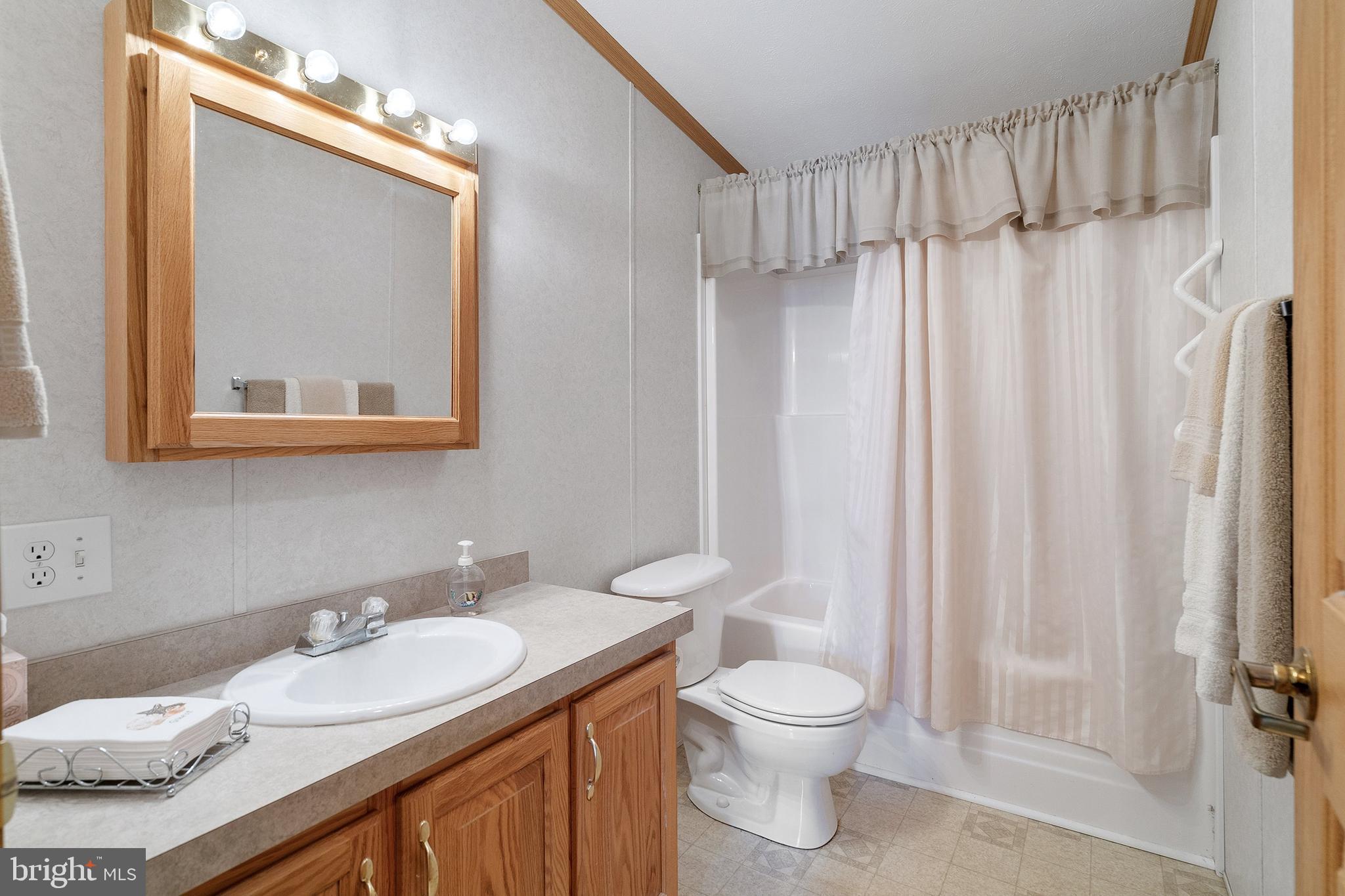 1104 Sycamore Court Whiting, NJ 08759 - Photo 26 of 54 a bathroom with a granite countertop sink toilet and shower