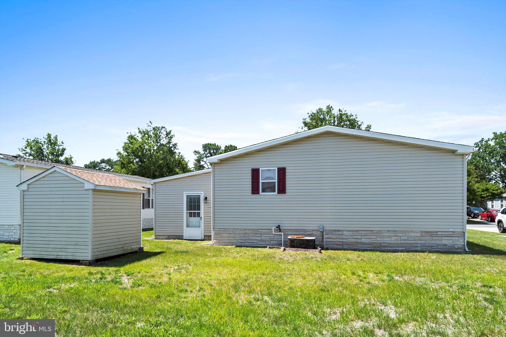 1104 Sycamore Court Whiting, NJ 08759 - Photo 30 of 54 a backyard of a house with plants and a large tree