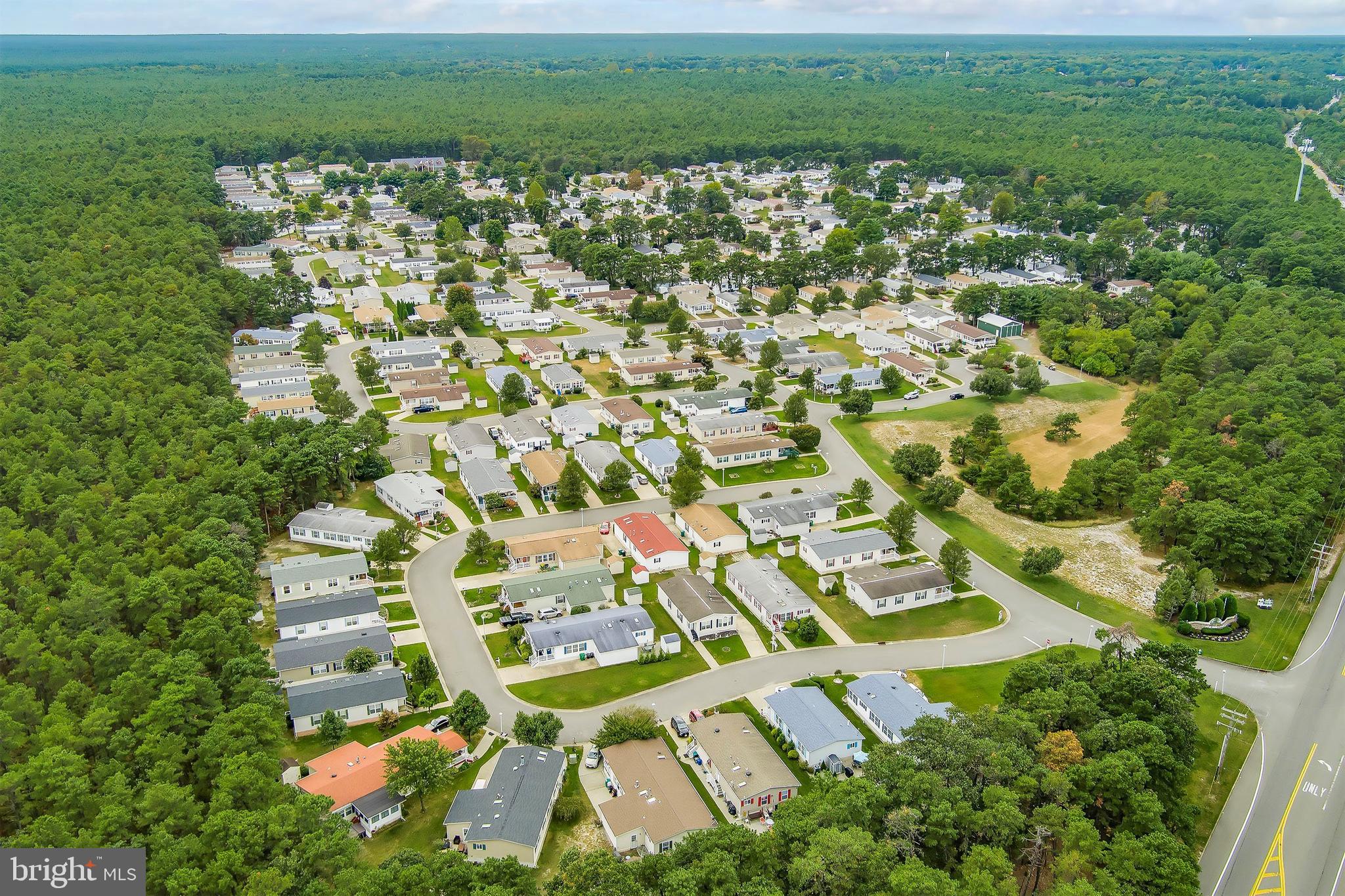 1104 Sycamore Court Whiting, NJ 08759 - Photo 36 of 54 a view of a white house with a yard